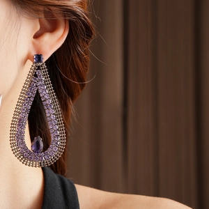 Detail showing vintage purple zircon teardrop earrings with black mesh and crystal stones