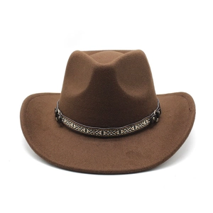 Detail of coffee brown wool felt cowboy hat featuring a tribal geometric band and metal studs