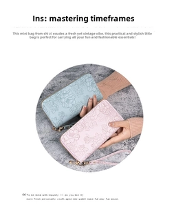 Detail of long floral embossed PU leather wallets in pink and blue with wrist straps