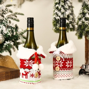 Detail of Christmas wine bottle covers with knitted reindeer patterns and plush collars