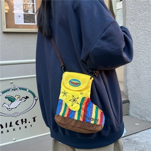 Quirky cowboy boot shaped plush shoulder bag in yellow with colorful rainbow stripes