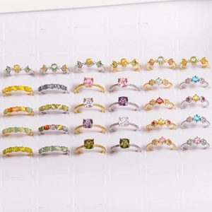 Collection of colorful zircon and pearl flower rings in various gold and silver styles