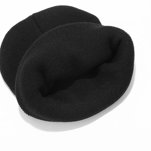 Detailed top view of black ribbed knit beanie showing soft texture and folded cuff