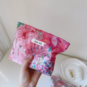 Detailed close-up of liberty floral makeup bag with simple wish label and zip