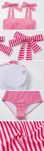 Close-up of red and white striped swimsuit with bow shoulder straps and removable pads