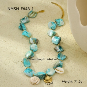 Detail view of ocean-style necklace with blue shell pieces and golden scallop pendant