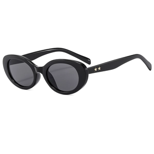 Retro oval black sunglasses with gold star accents and grey lenses in a 45-degree view