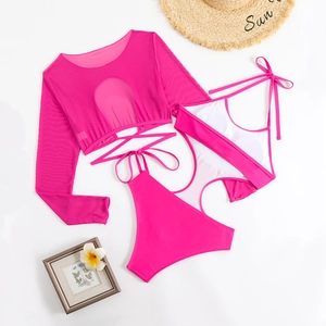 Detailed flat lay of rose red three-piece swimwear with mesh cover-up and sun hat