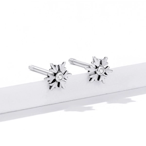 Macro shot of silver S925 snowflake stud earrings with sparkling cubic zirconia centers