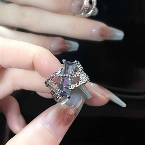 Detailed macro of thorn textured silver ring featuring a rectangular rainbow zircon stone