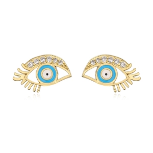 Macro detail of 18K gold plated evil eye earrings with blue enamel and clear zircons