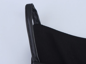Detail of the black PU leather shoulder strap stitched onto the ribbed fabric dress
