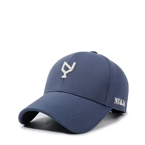 Detailed view of dark blue baseball cap with white geometric 3D embroidery and side lettering