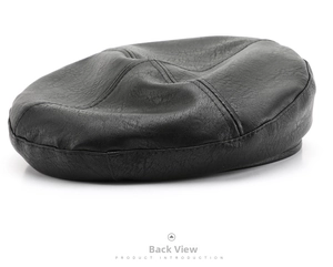 Rear view of a black faux leather newsboy cap with detailed lychee grain texture