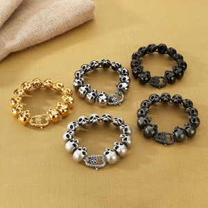 Vintage stainless steel skull bracelets in five metallic colors for men on a textured base