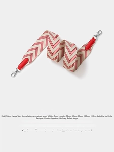 Detail of red and white chevron embroidered strap with leather ends and silver clips