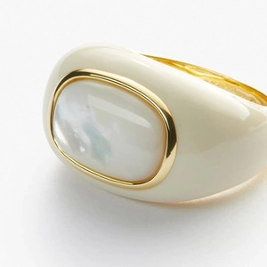 Detail of 18k gold plated ring with white mother of pearl and cream enamel finish