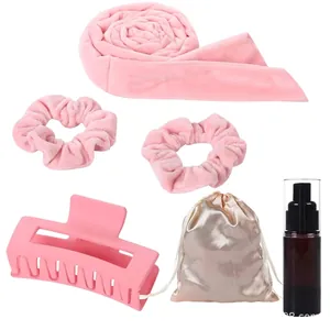 Pink heatless hair curler set with velvet scrunchies, large hair claw, and spray bottle