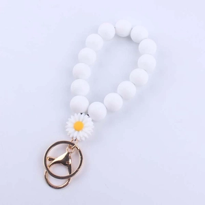 Daisy beaded silicone wristlet keychain with white beads and golden metal hardware