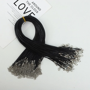Close-up of black wax cord necklace chains with silver metal lobster clasps for pendants