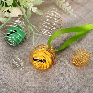 DIY metal lantern spring ball pendants with colorful bells on grey textured background