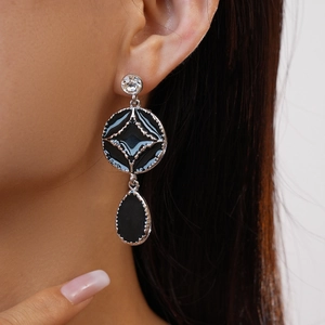 Gothic style silver-toned drop earrings with black enamel circles and teardrop charms
