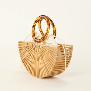 Handmade semi-circle hollow bamboo tote bag with round amber resin handles and inner pouch