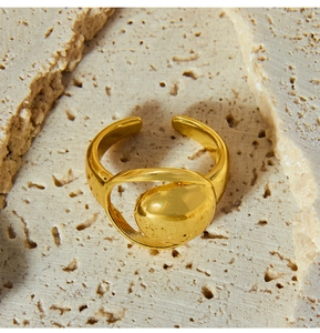 Detail of a gold adjustable ring featuring a polished irregular hollow crescent moon shape
