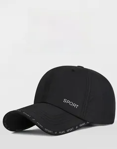 Detail of black quick-dry baseball cap featuring breathable laser-cut holes and FEWK logo