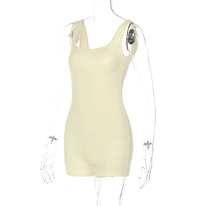 Detail of light yellow sleeveless ribbed romper showing stretchy knit fabric texture