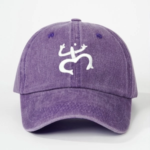 Detail of white Coquí frog embroidery on vintage washed purple cotton baseball cap