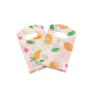 Detail of 9x15cm plastic gift bags with orange and floral print on pink background