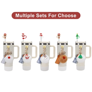 Christmas themed straw covers and plush ball charms for Stanley tumblers in multiple sets