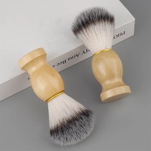 Close-up of wooden shaving brushes with soft synthetic bristles and gold metal ferrule
