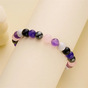 Macro detail of 8mm natural stone beaded bracelet with gradient multicolor beads on display