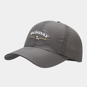 Close-up of quick-dry baseball cap featuring laser-cut ventilation and embroidered letters