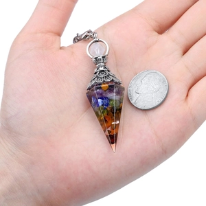 Chakra crystal pendulum necklace size comparison with coin in hand display