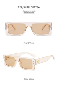 Detailed view of tea-colored oversized sunglasses with gold bee metal decoration