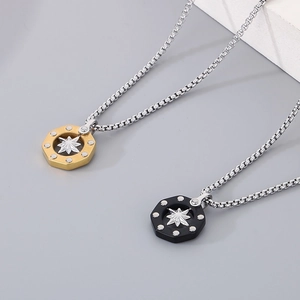 Detail of hex nut pendants in gold and black with silver star on box chain necklaces