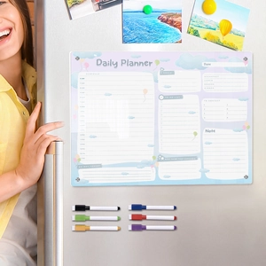 Close-up of magnetic acrylic daily planner on fridge with cloud design and colorful markers