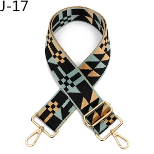 Detail of adjustable geometric strap with gold metal swivel hooks and buckles