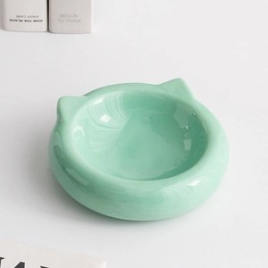 Minimalist mint green ceramic cat-ear shaped pet bowl with elegant marble texture