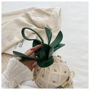 Detail of creative pineapple crossbody bag with white quilted leather and gold studs