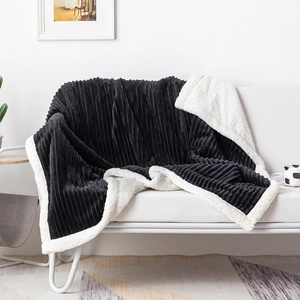 Detail of black striped fleece and white sherpa lining on a thick double-layer blanket