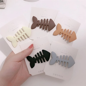 Set of five colorful matte fishbone hair clips in cream, brown, black, and grey colors