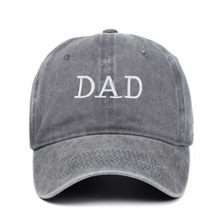 Detailed close-up of white DAD embroidery on dark grey vintage washed cotton baseball cap
