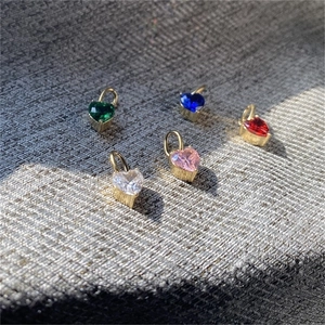 Detailed view of colorful heart-shaped zircon charms with 14K gold-plated metal settings