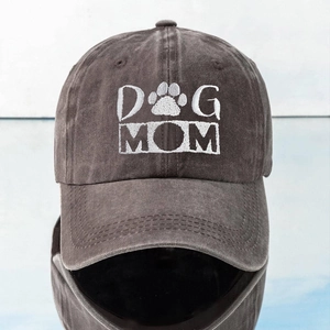 Detail of the Dog Mom embroidery and dog paw motif on a washed cotton baseball cap