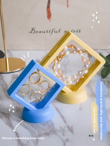 Detailed view of PE film jewelry boxes in blue and yellow showing floating ring display