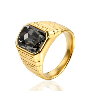 Detailed view of men's gold titanium ring featuring a square black onyx with geometric engraving